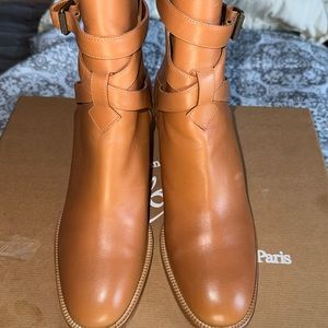 Tan colored with red bottom casual boots by Christian Louboutin
